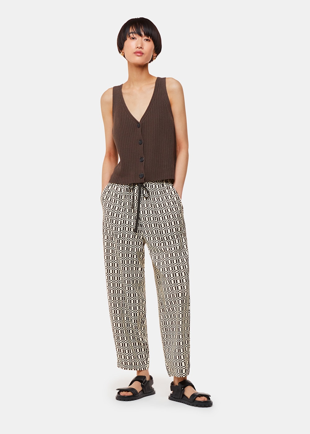 Whistles print trousers are Crafted with a unique print, our Link Check Print Trouser will elevate your spring-summer styles. Light on the body, it comes fitted at the waist and it’s been designed in a carrot shape. Pair it with its matching top and trendy ballet pumps.
